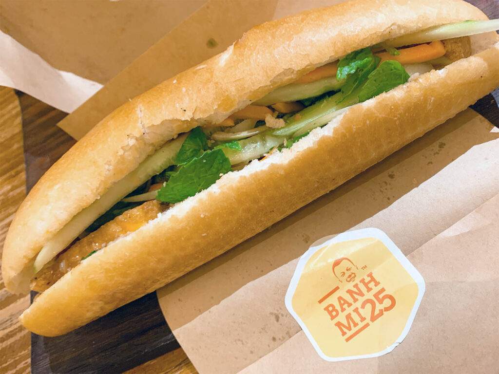 soft baguette filled with pork, leafy greens and pickled veggies.